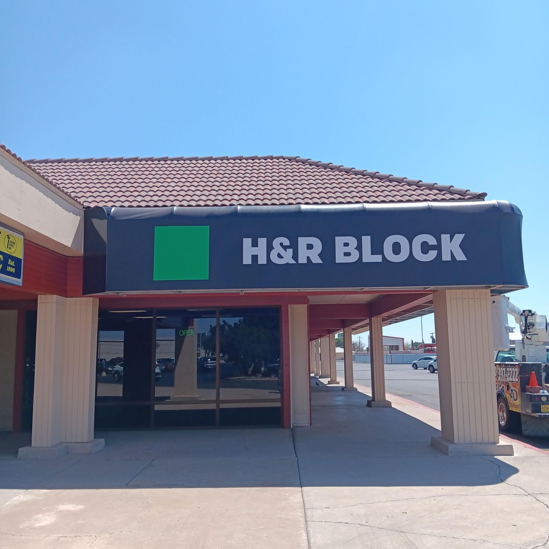 A building with a sign that says h & r block