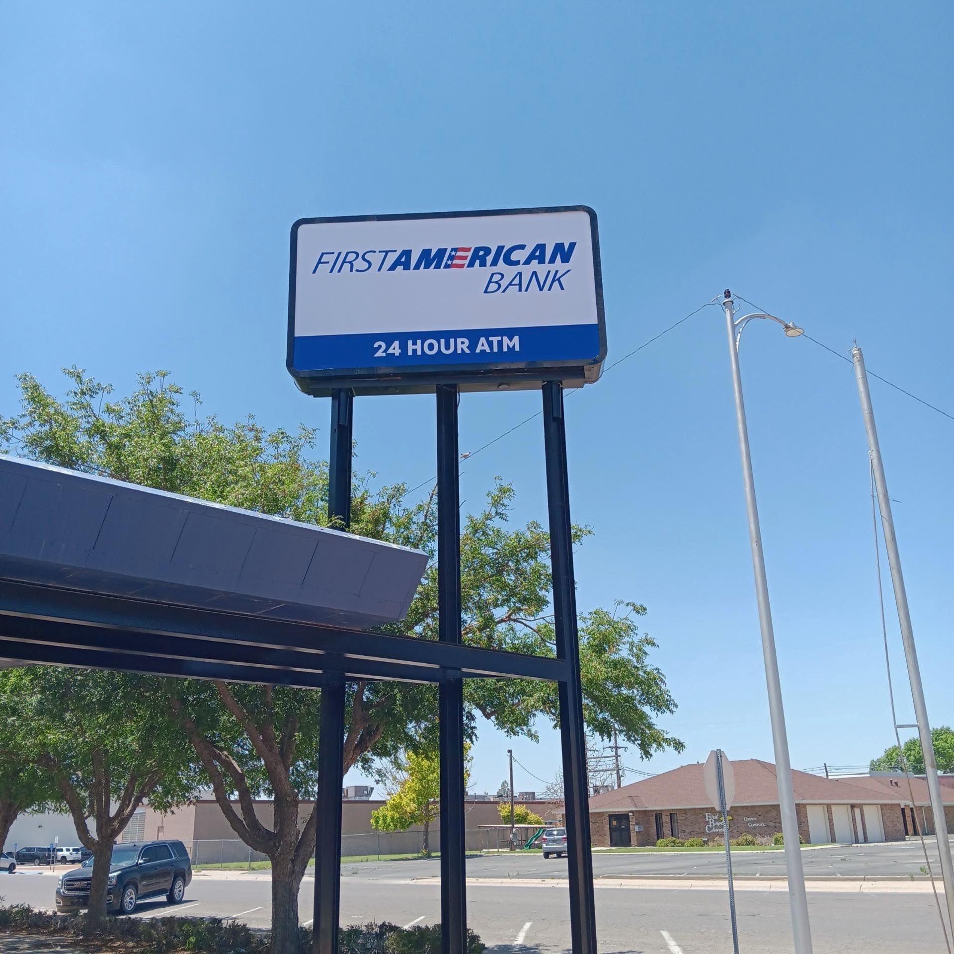 A blue and white sign for first american bank