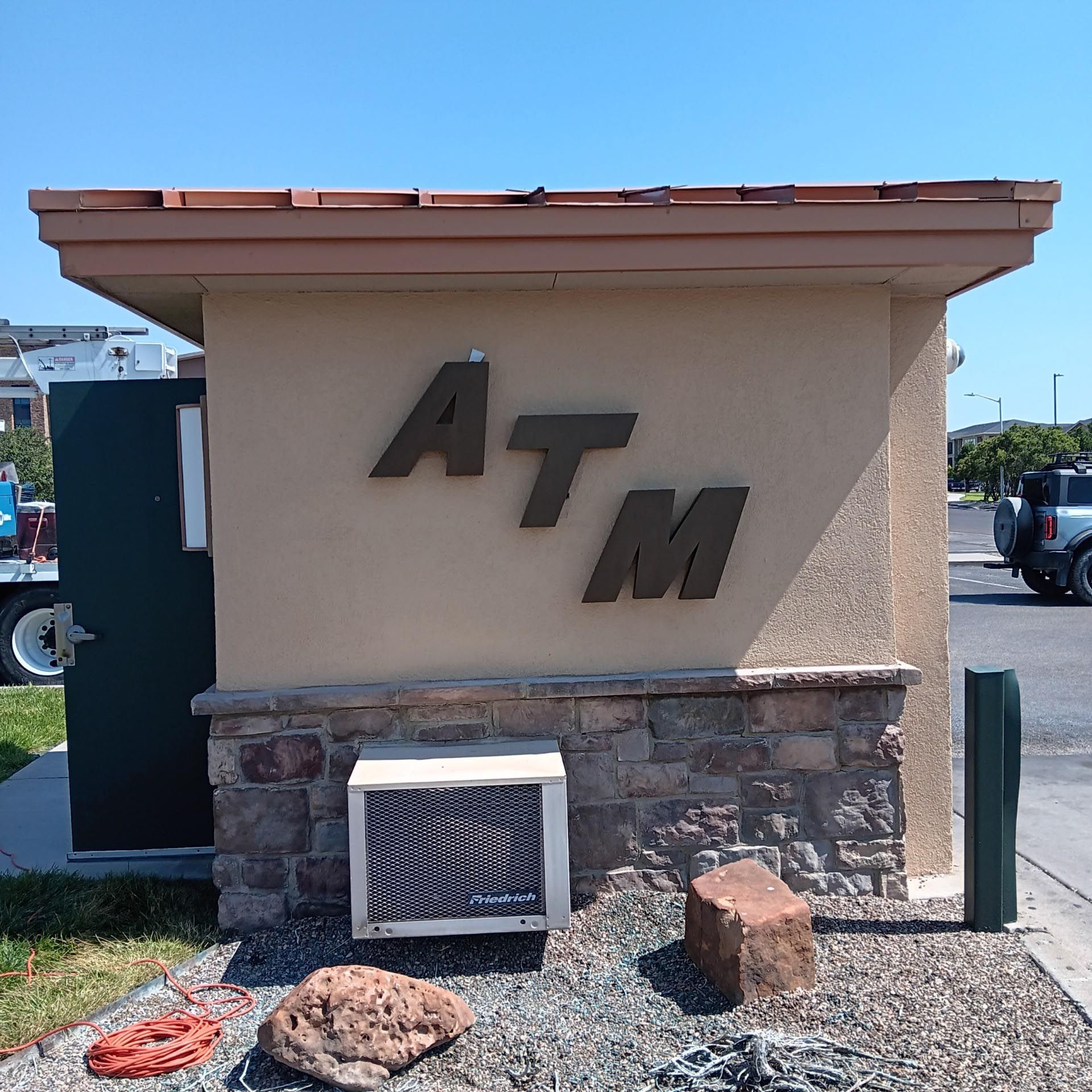 A small building with the word atm on it