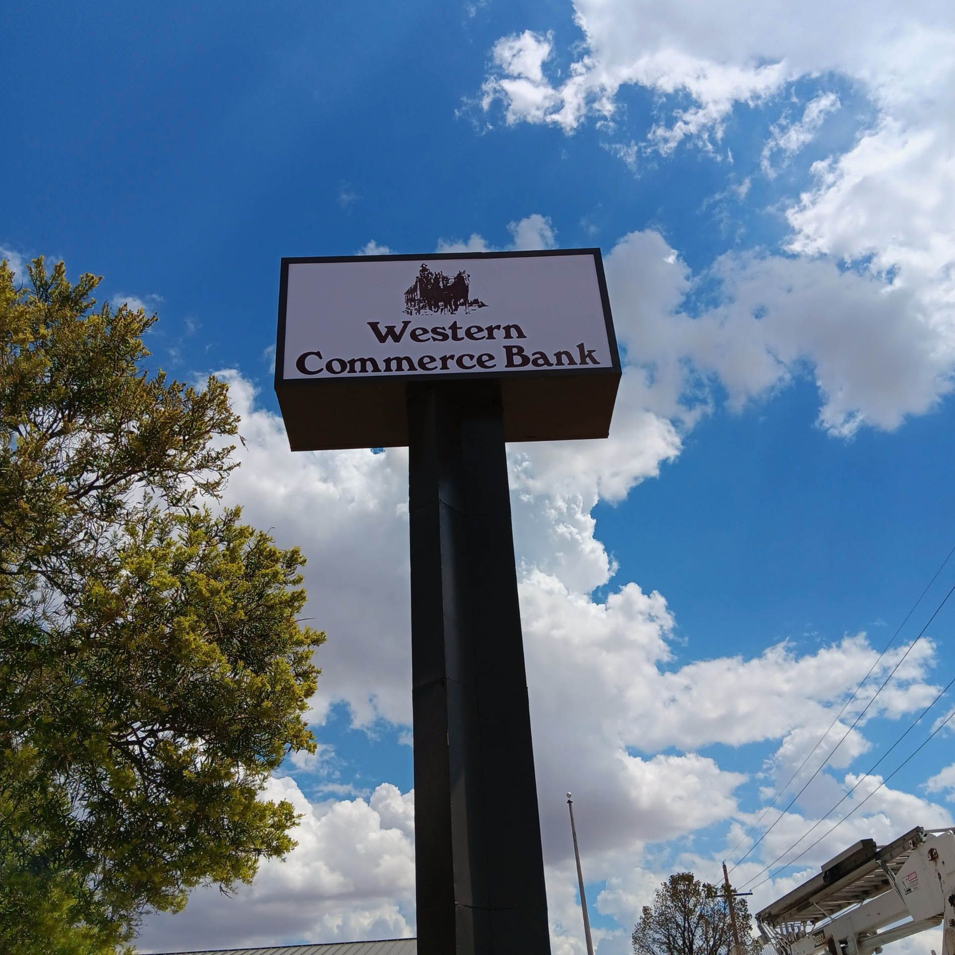 A sign for western commerce bank against a blue sky