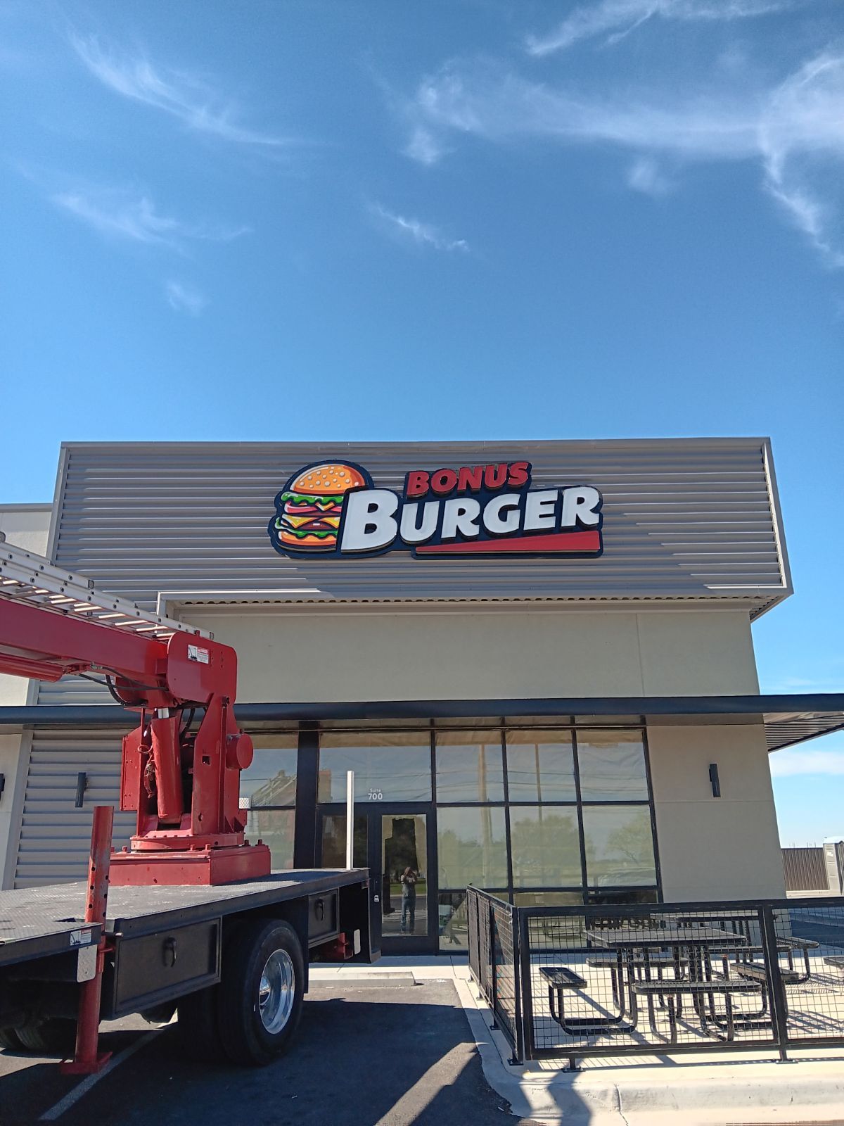 A truck is parked in front of a burger restaurant