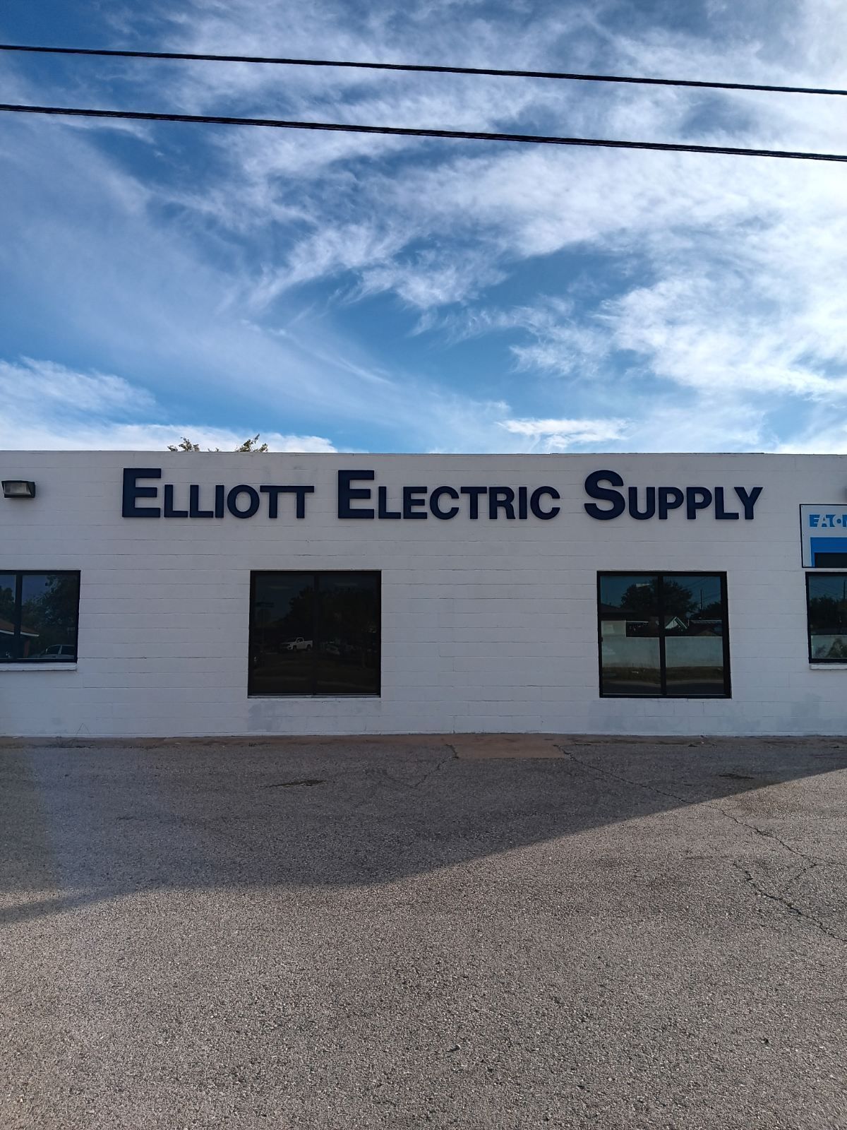 A white building that says elliott electric supply on it