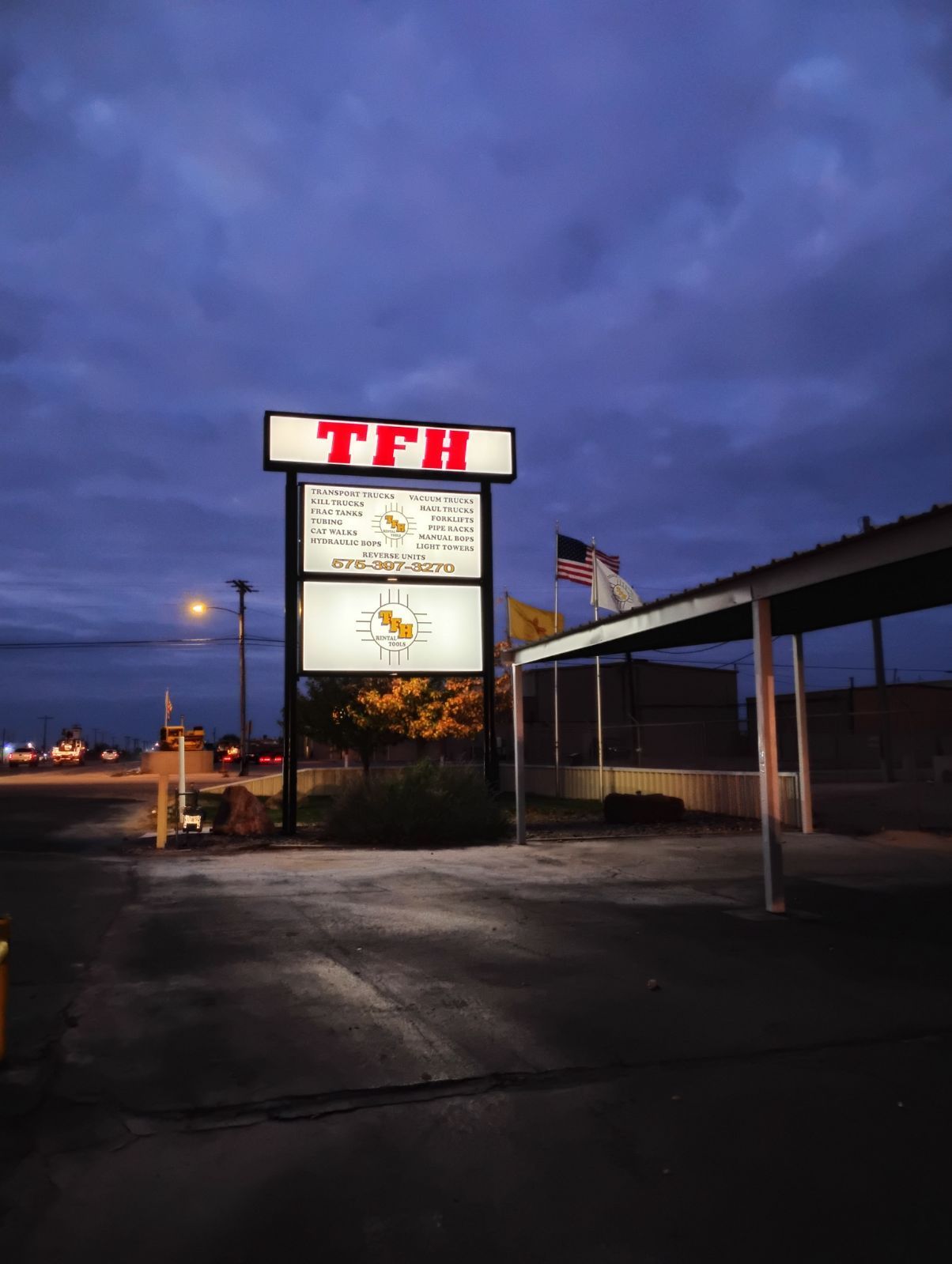 A large tfh sign is lit up at night