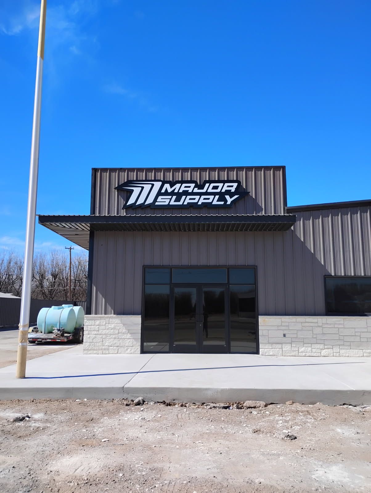 A large building with a sign that says major supply