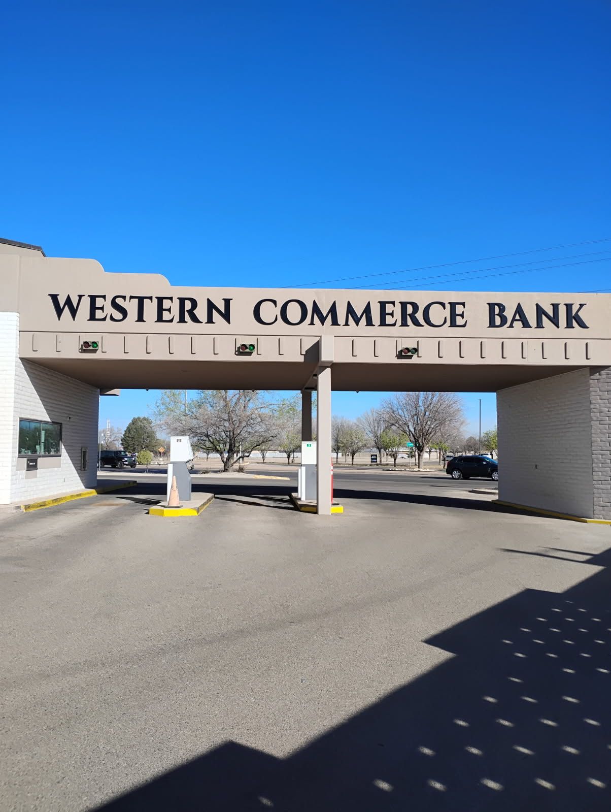 A western commerce bank building with a blue sky in the background