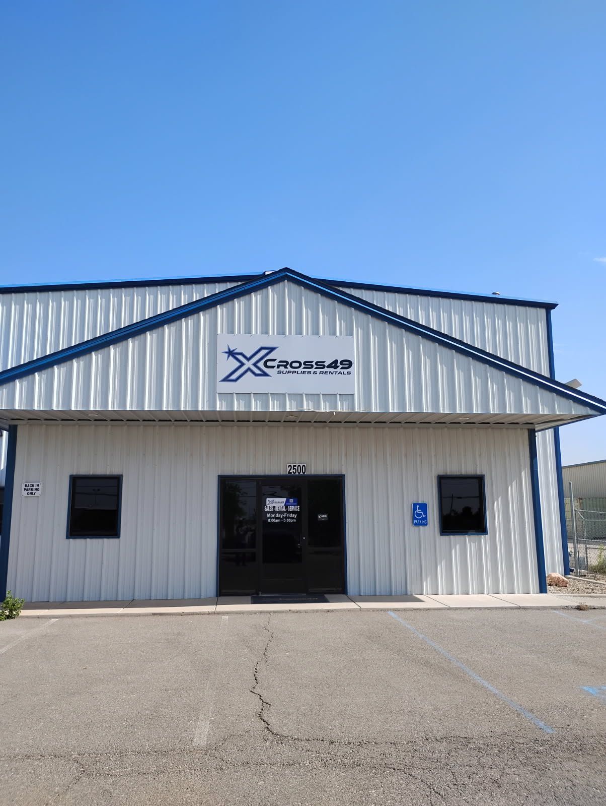 A building with a sign that says x cross49 supplies & rentals