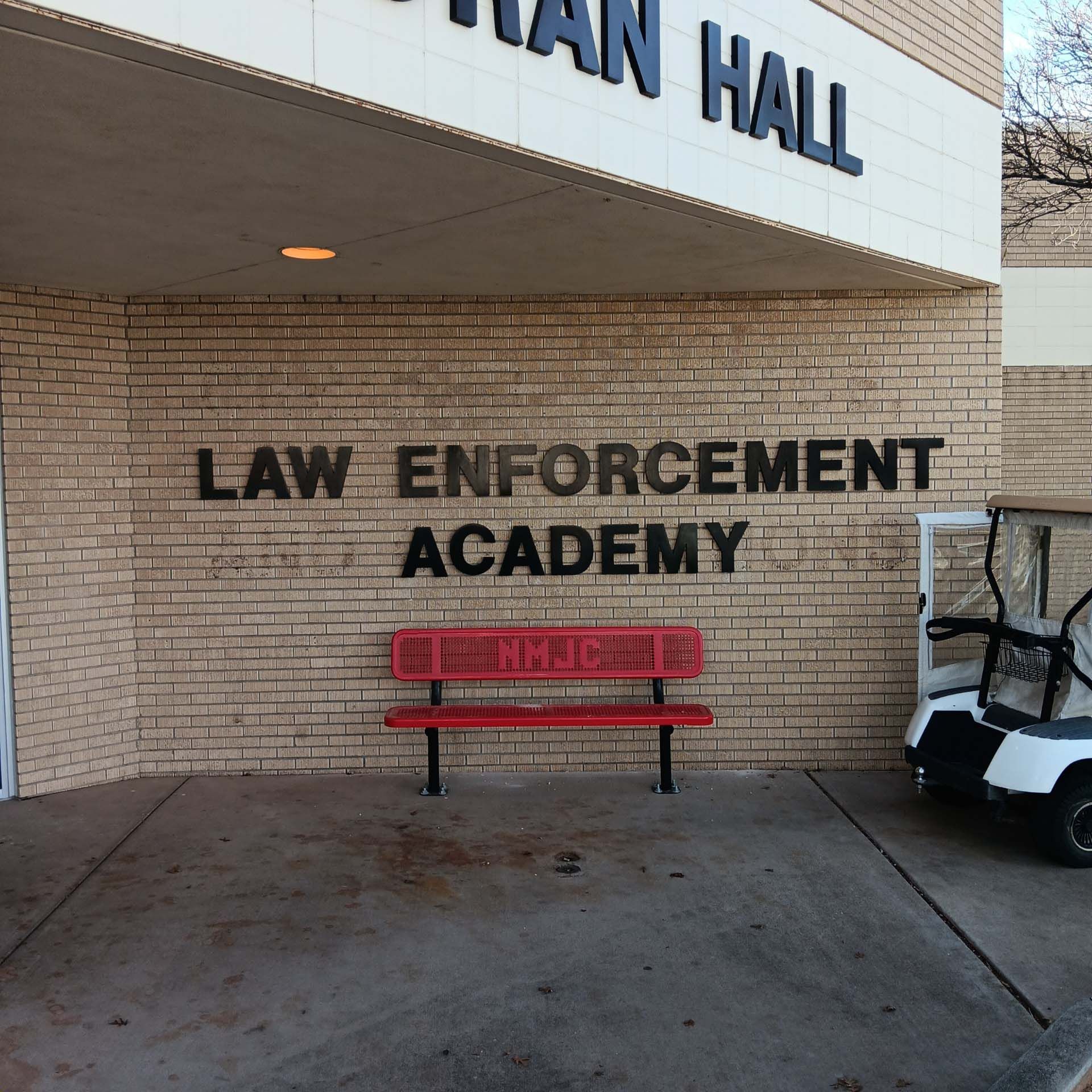 A brick wall with the words law enforcement academy on it