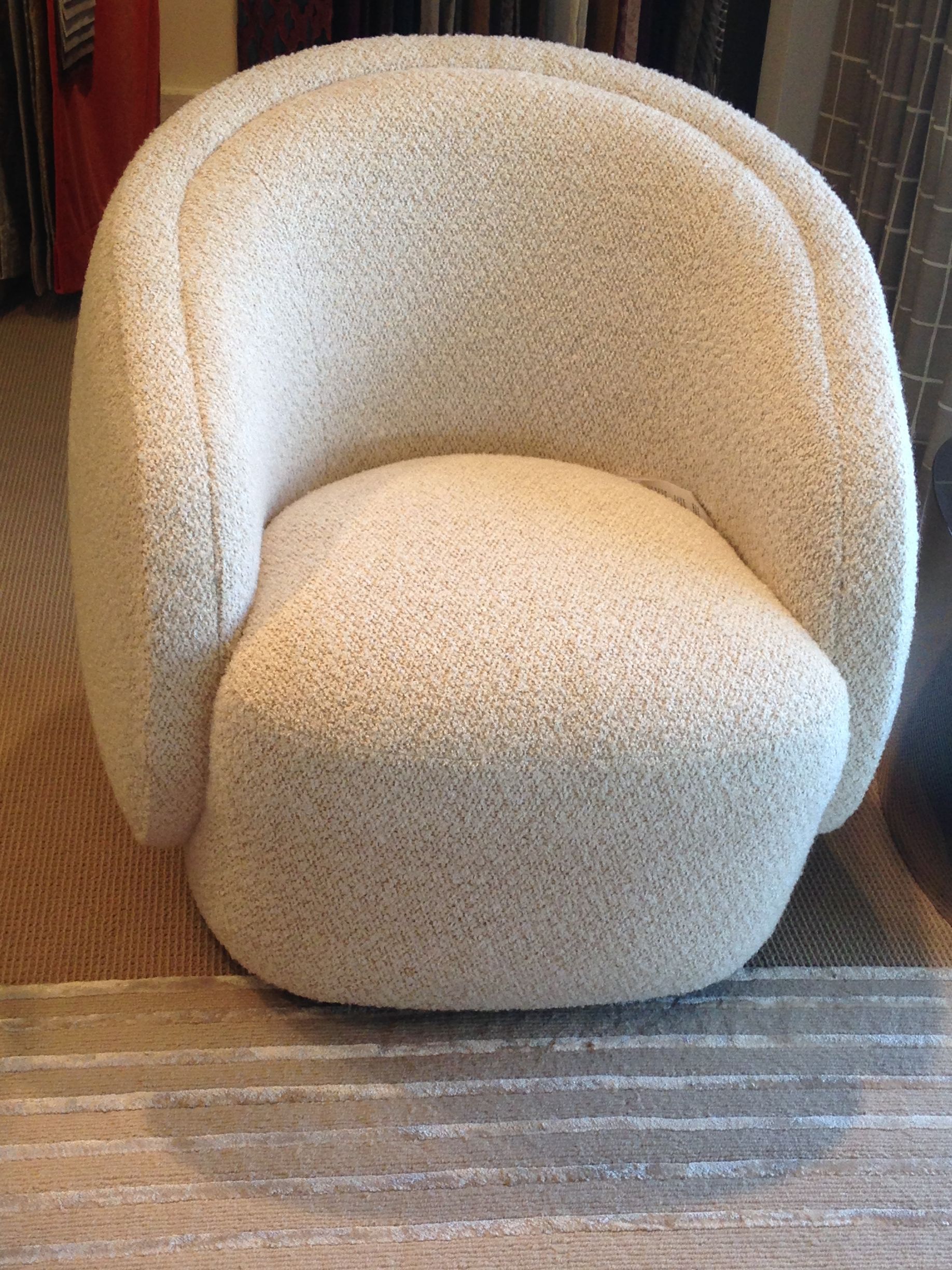 A white chair is sitting on a rug in a room.