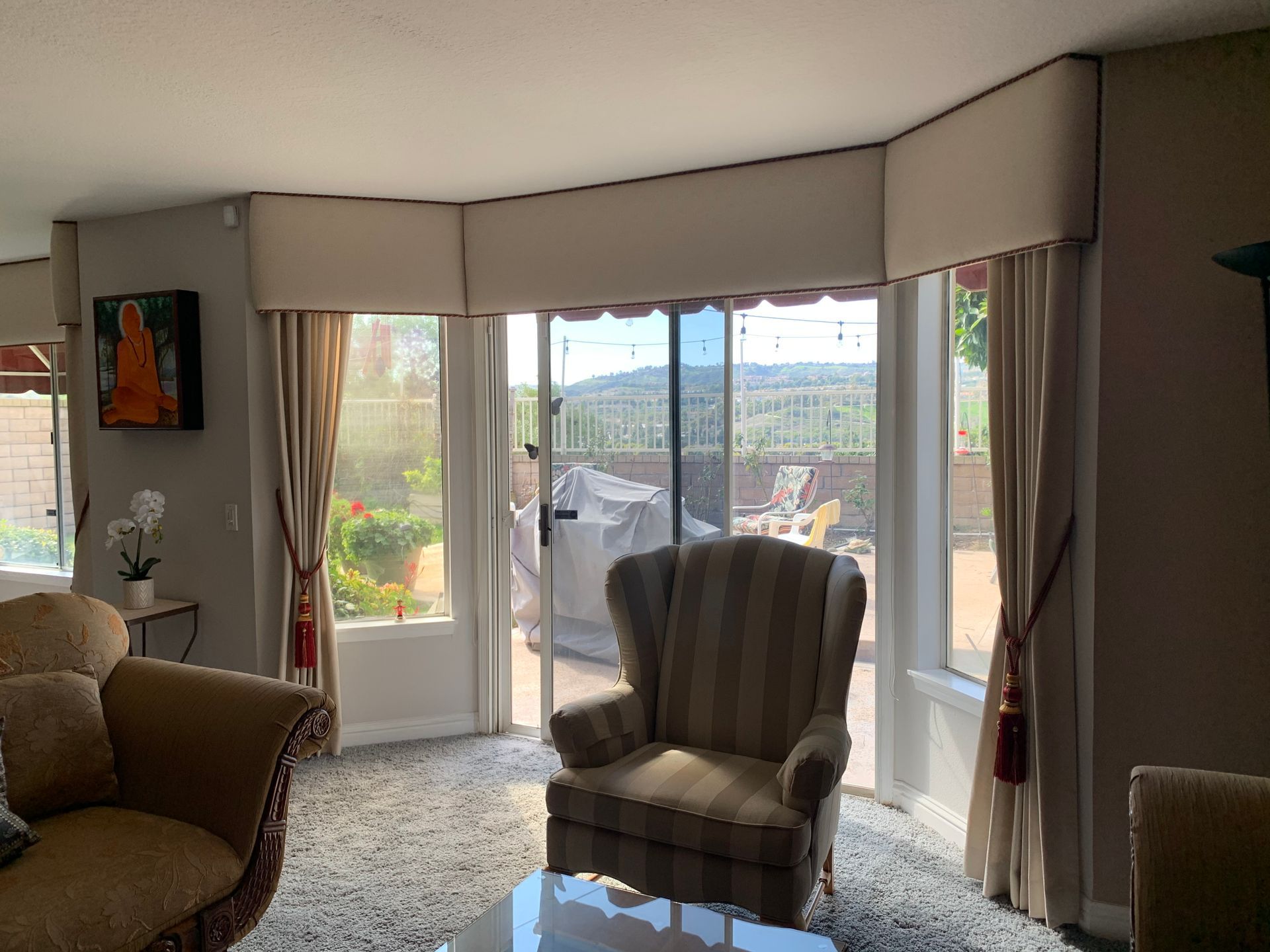 A living room with a couch , chair , table and sliding glass doors.
