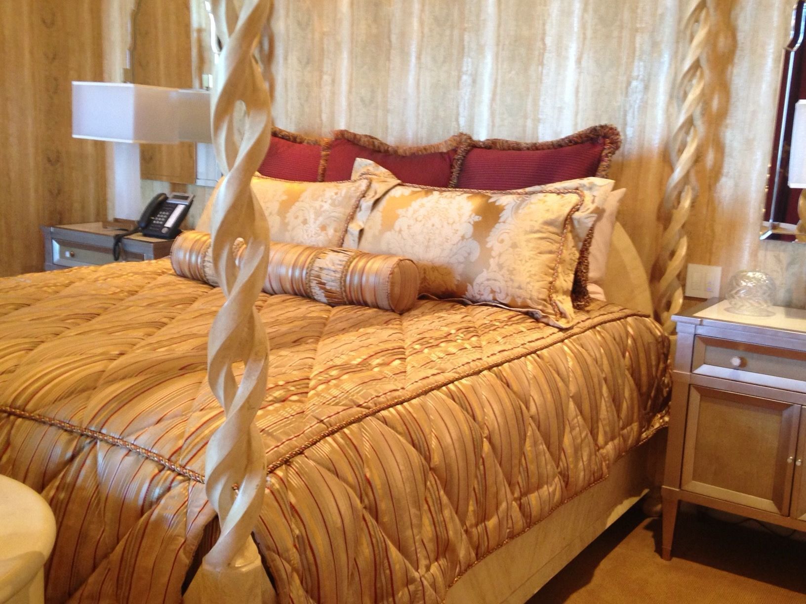 A bedroom with a canopy bed and a nightstand