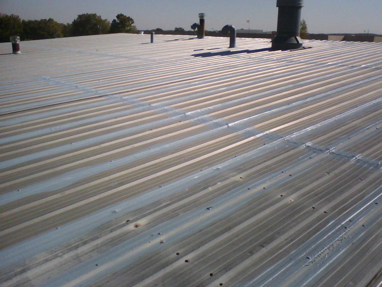 A metal roof with a chimney on top of it
