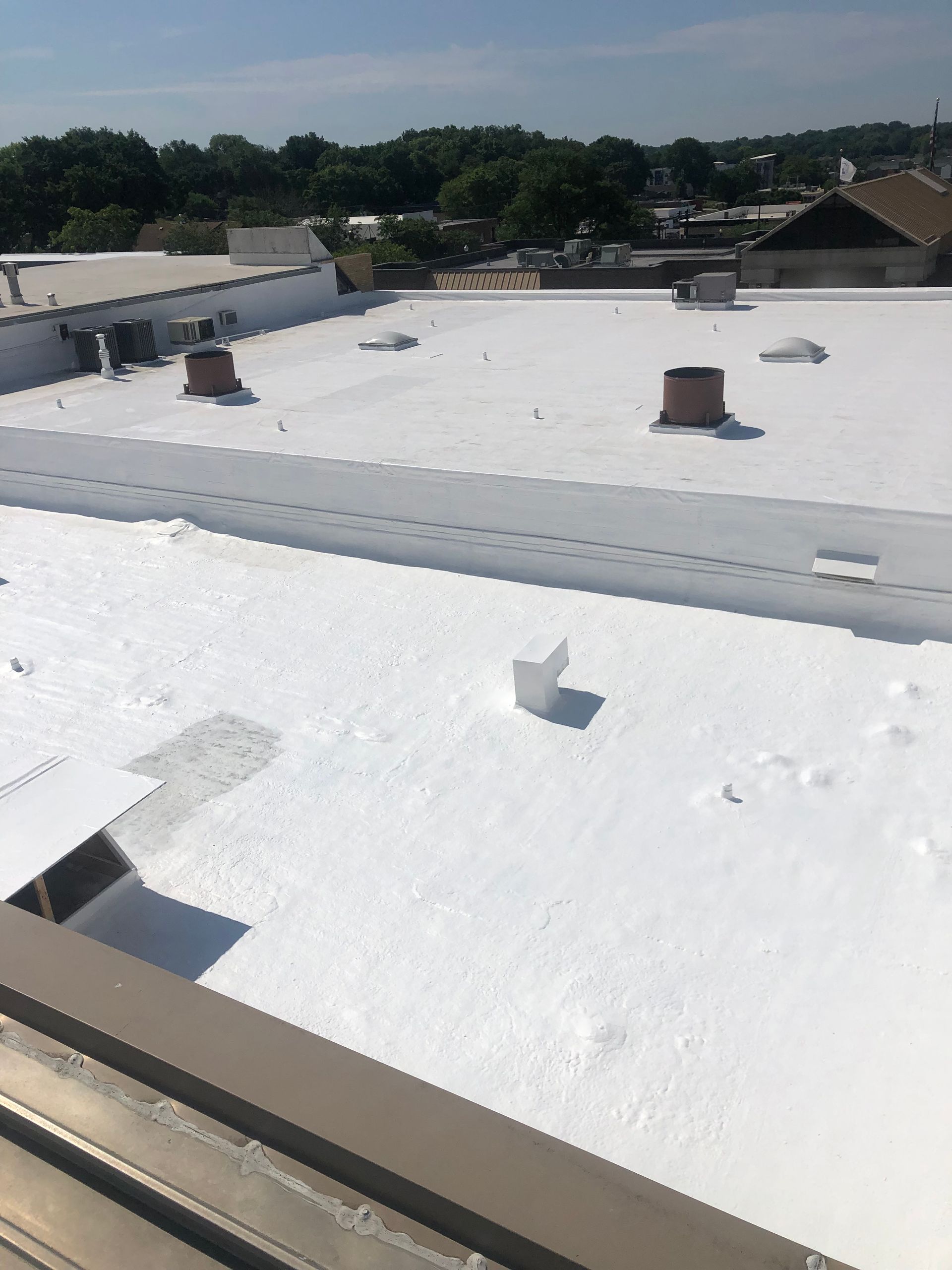 A white roof with a chimney on top of it
