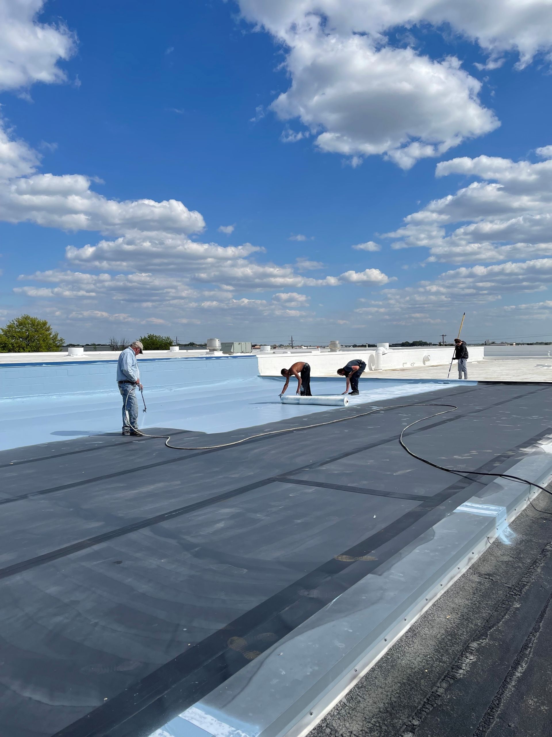 A group of people are working on a roof.