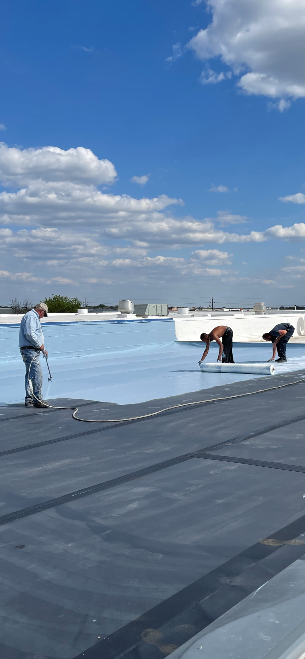 A group of people are working on a roof.