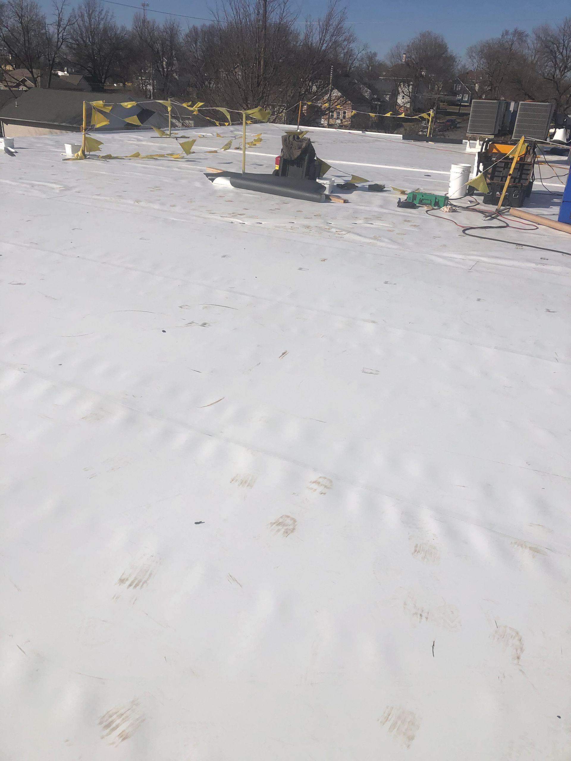 A snowy field with a tractor in the background