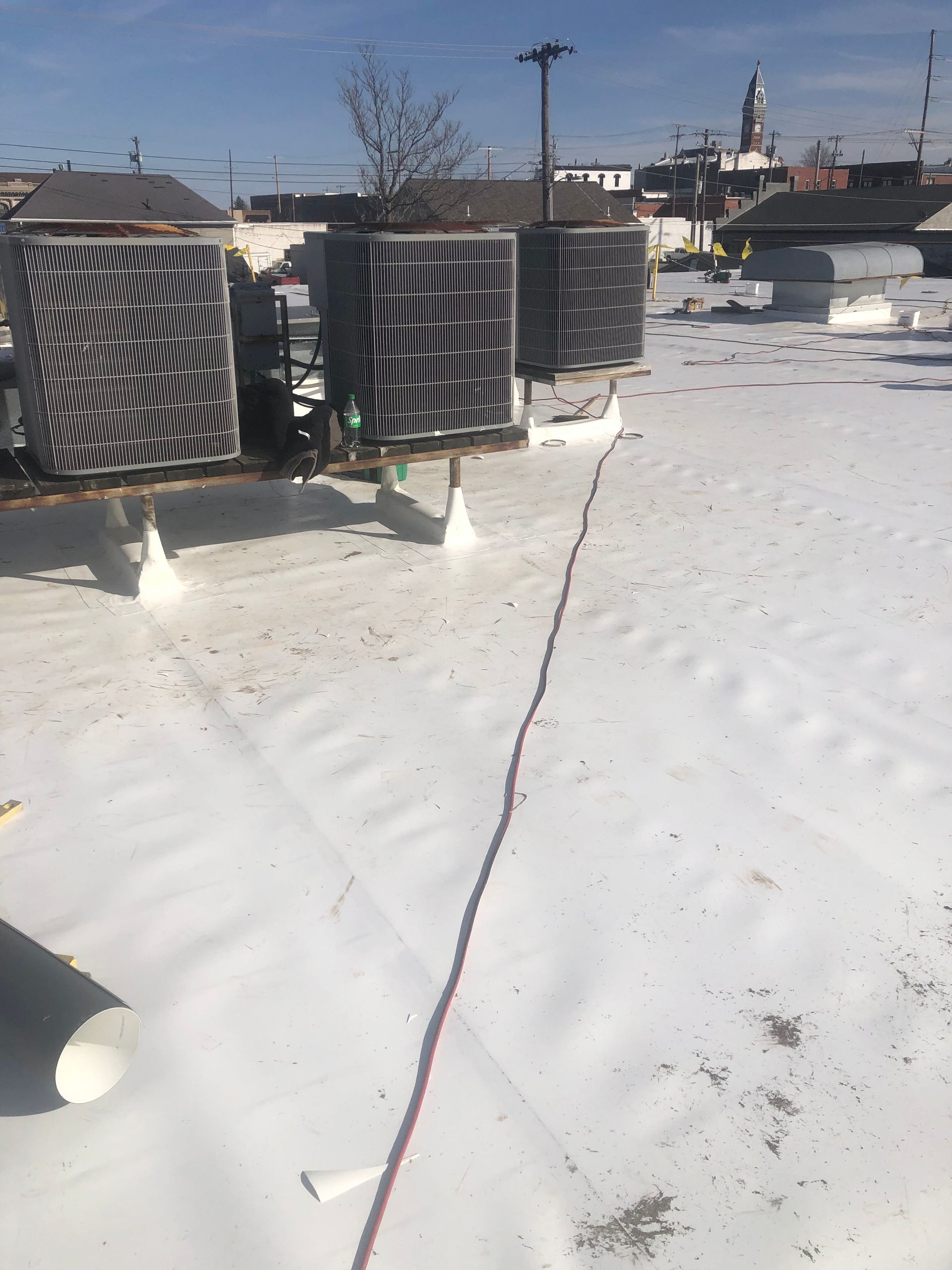 A roof with a lot of air conditioners on it