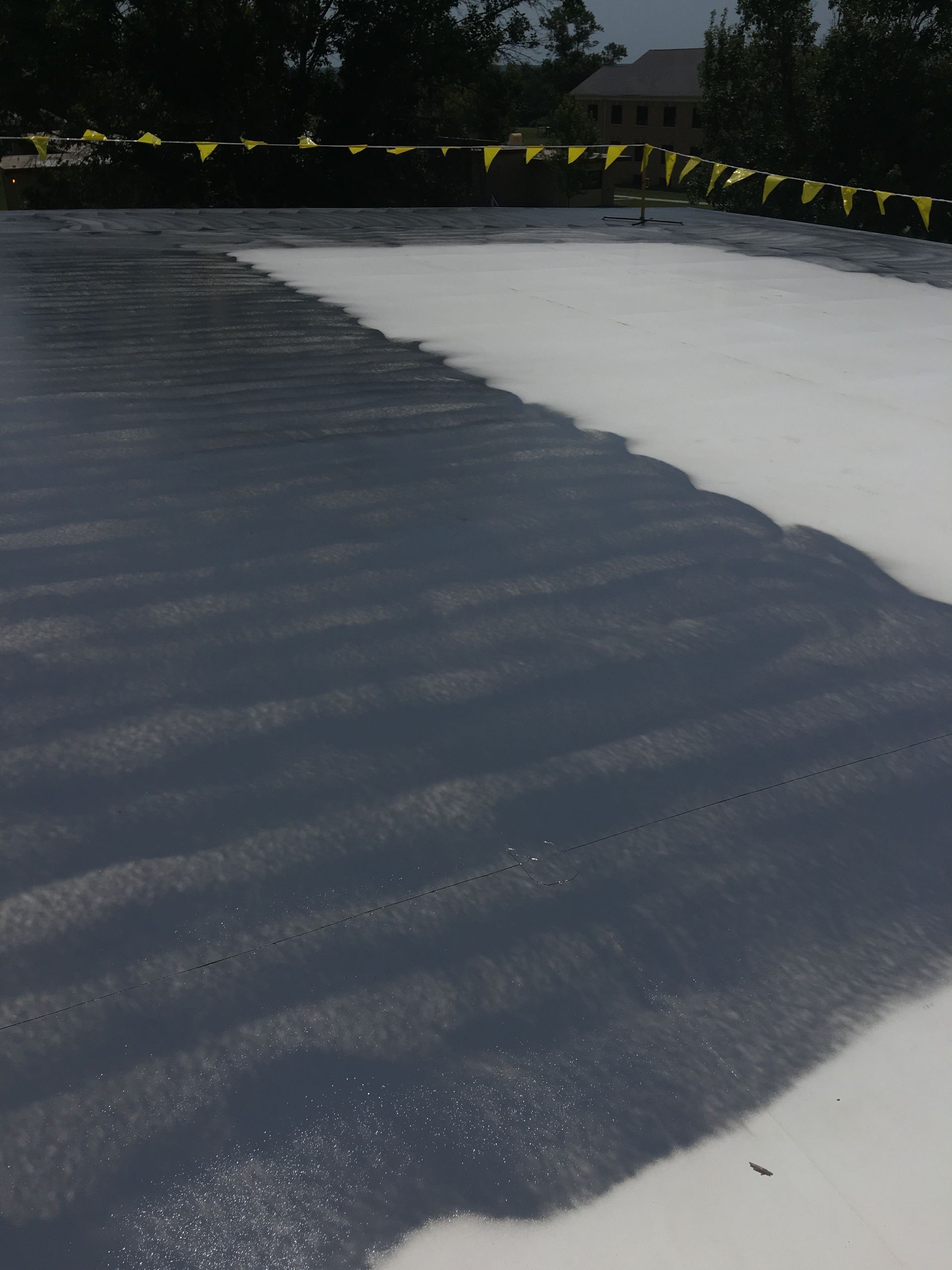 A large amount of foam is being applied to a roof.