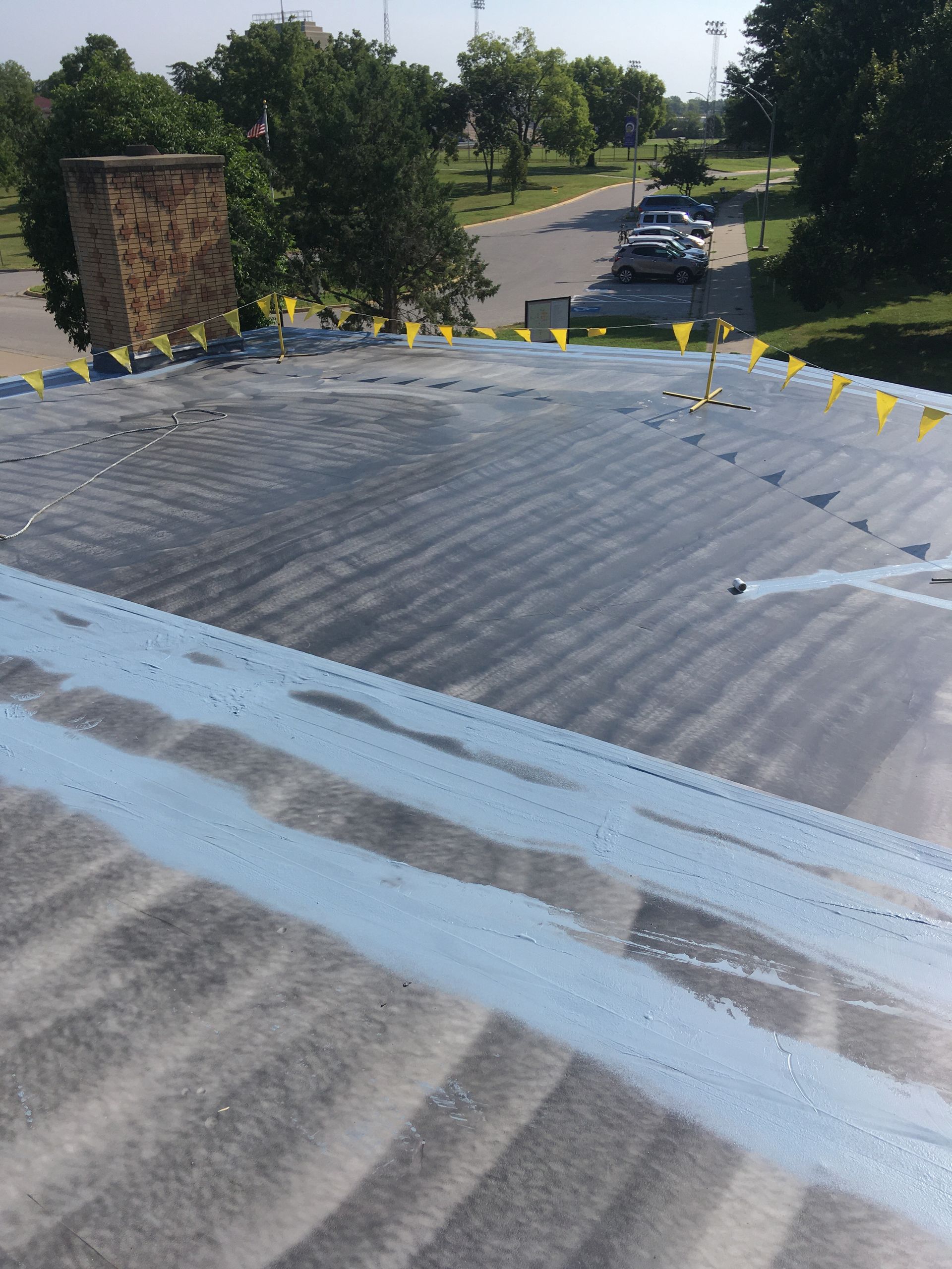 A roof with a lot of yellow flags on it