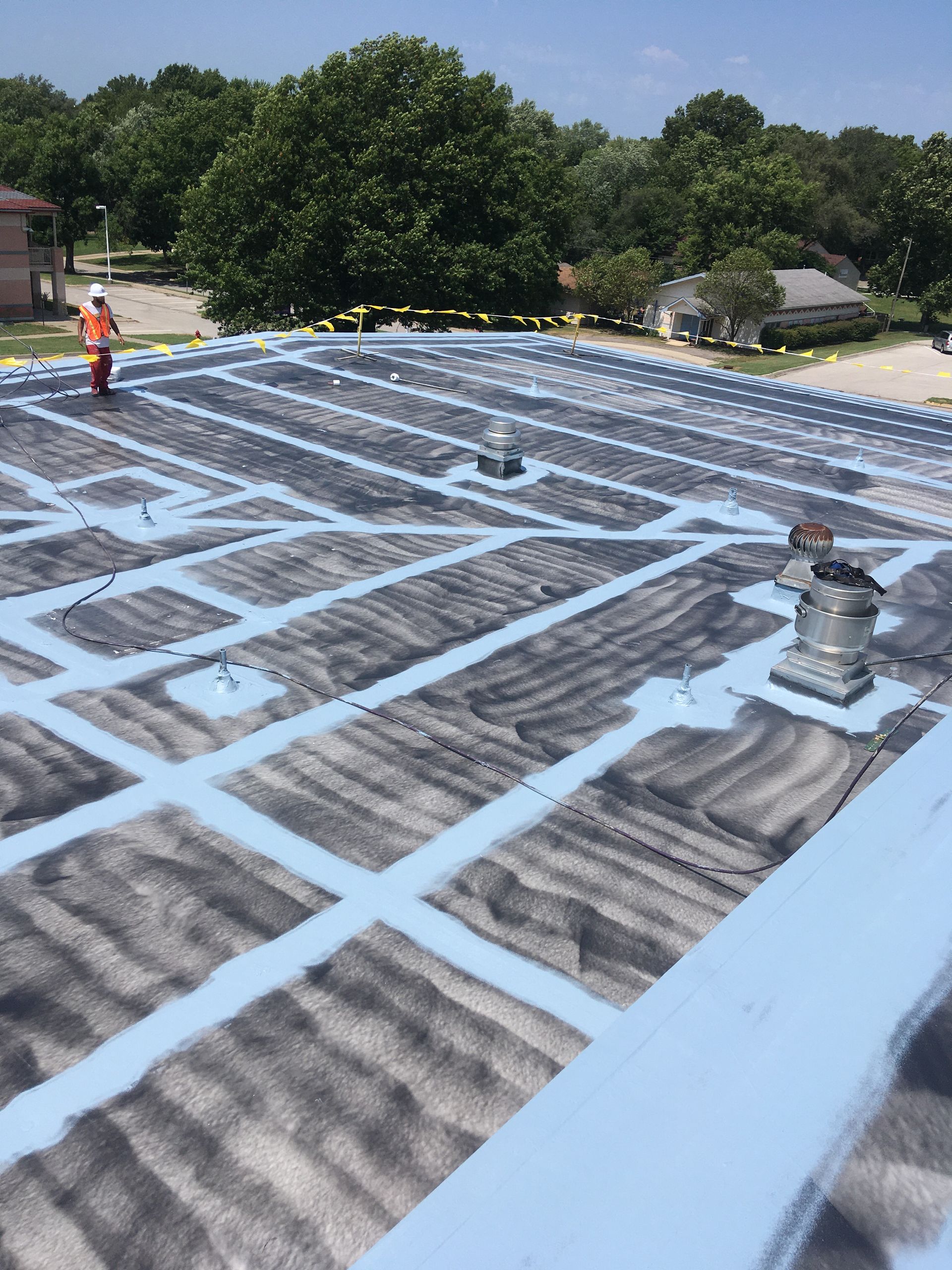 A man is standing on the roof of a building.