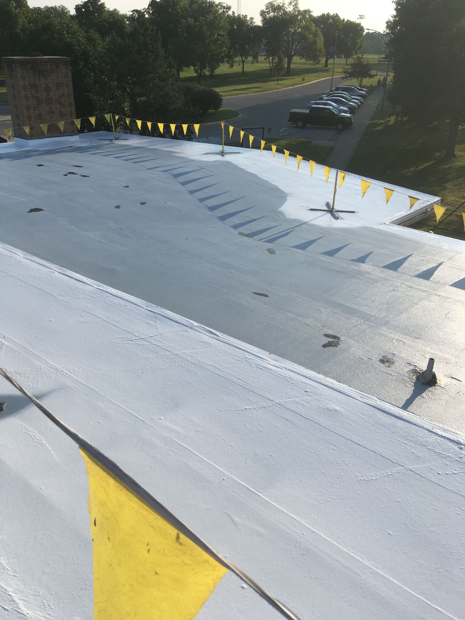 A white roof with yellow flags on it