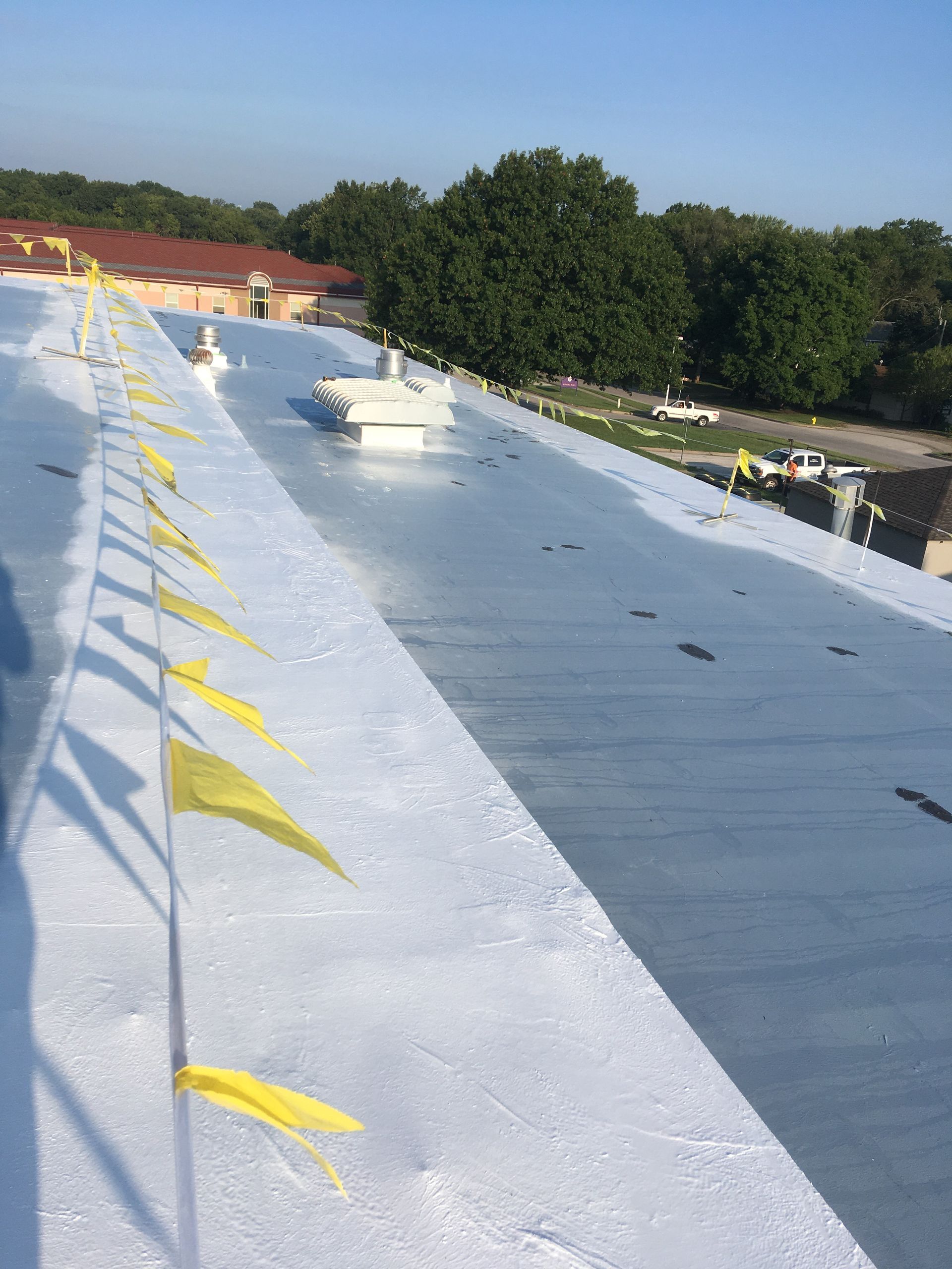 A roof with a lot of yellow flags on it