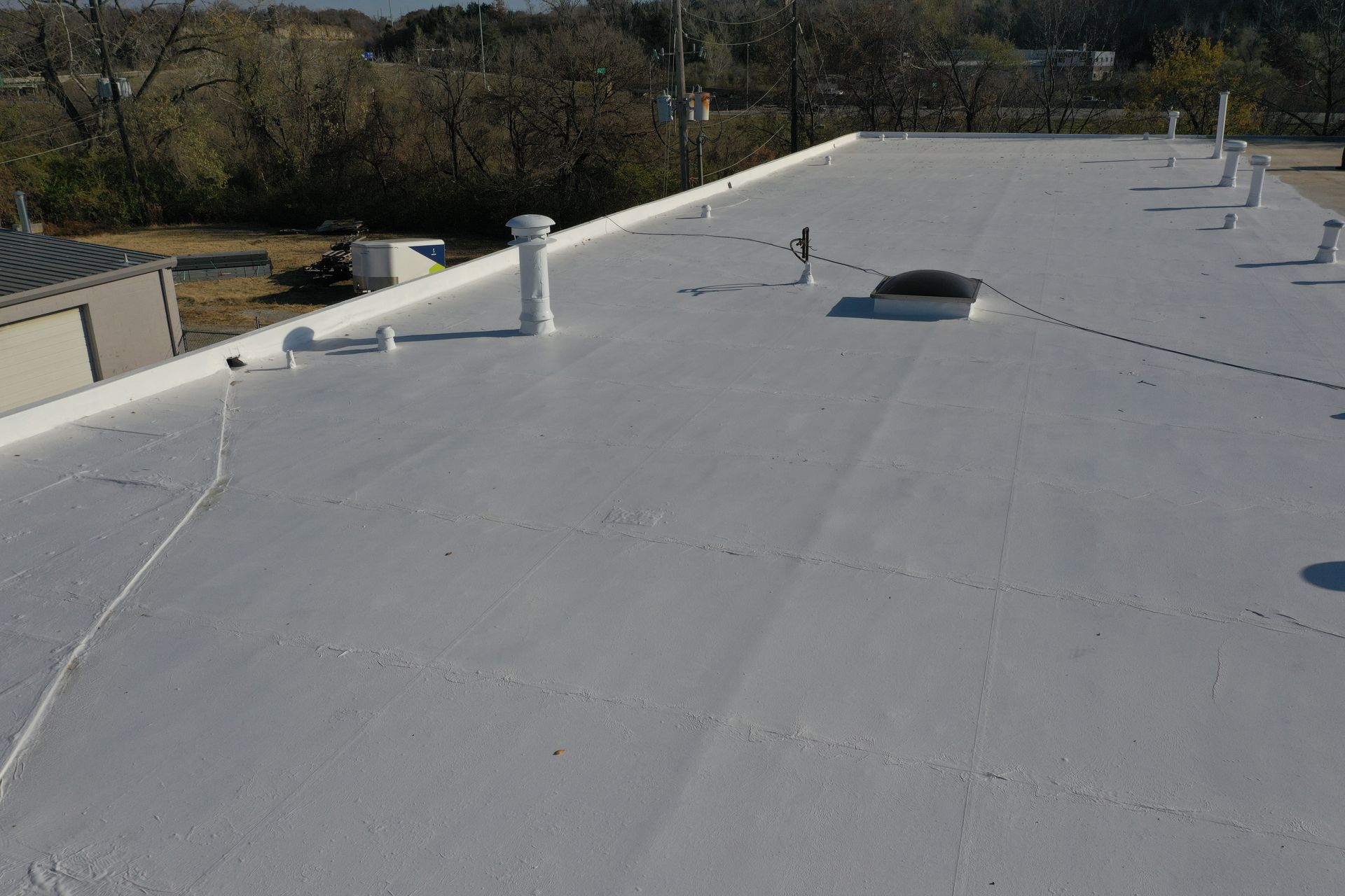 A white roof with a skylight on top of it.