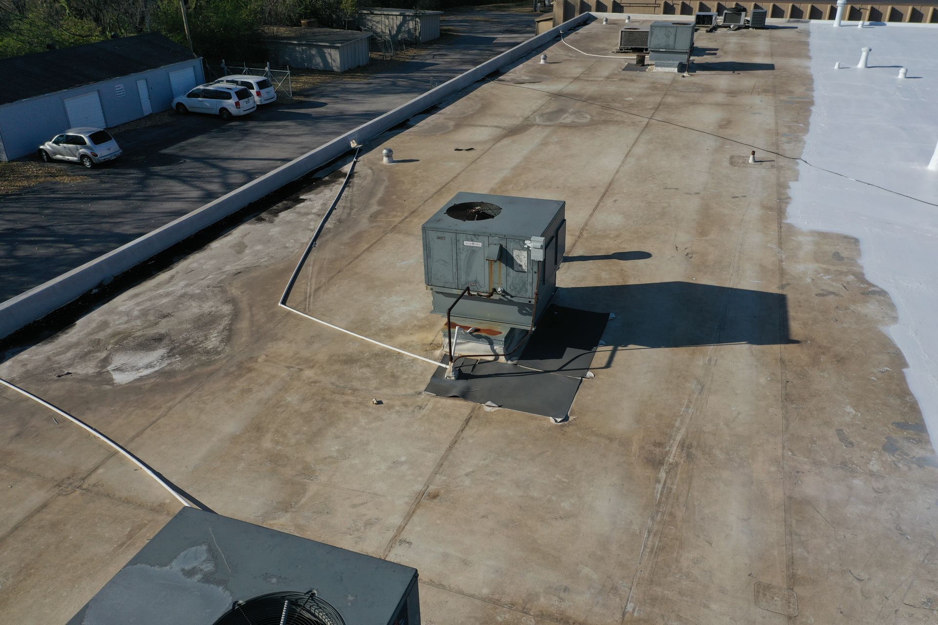 An aerial view of a roof with a lot of air conditioners on it