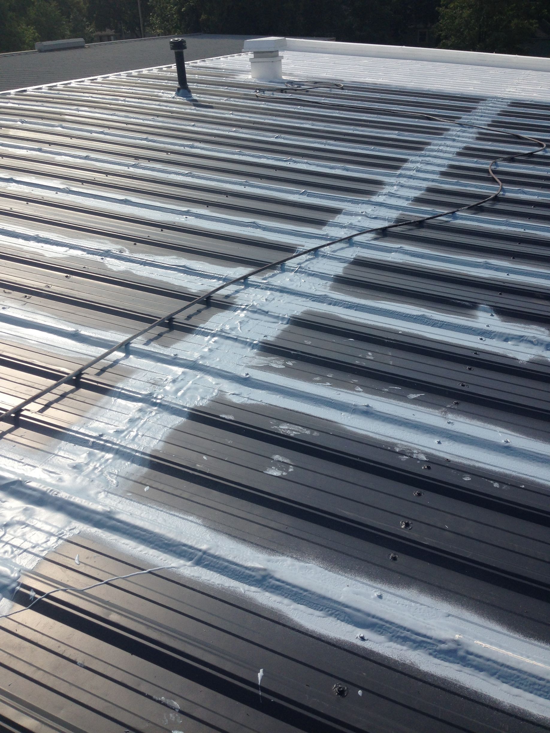 A close up of a roof with a white stripe on it.