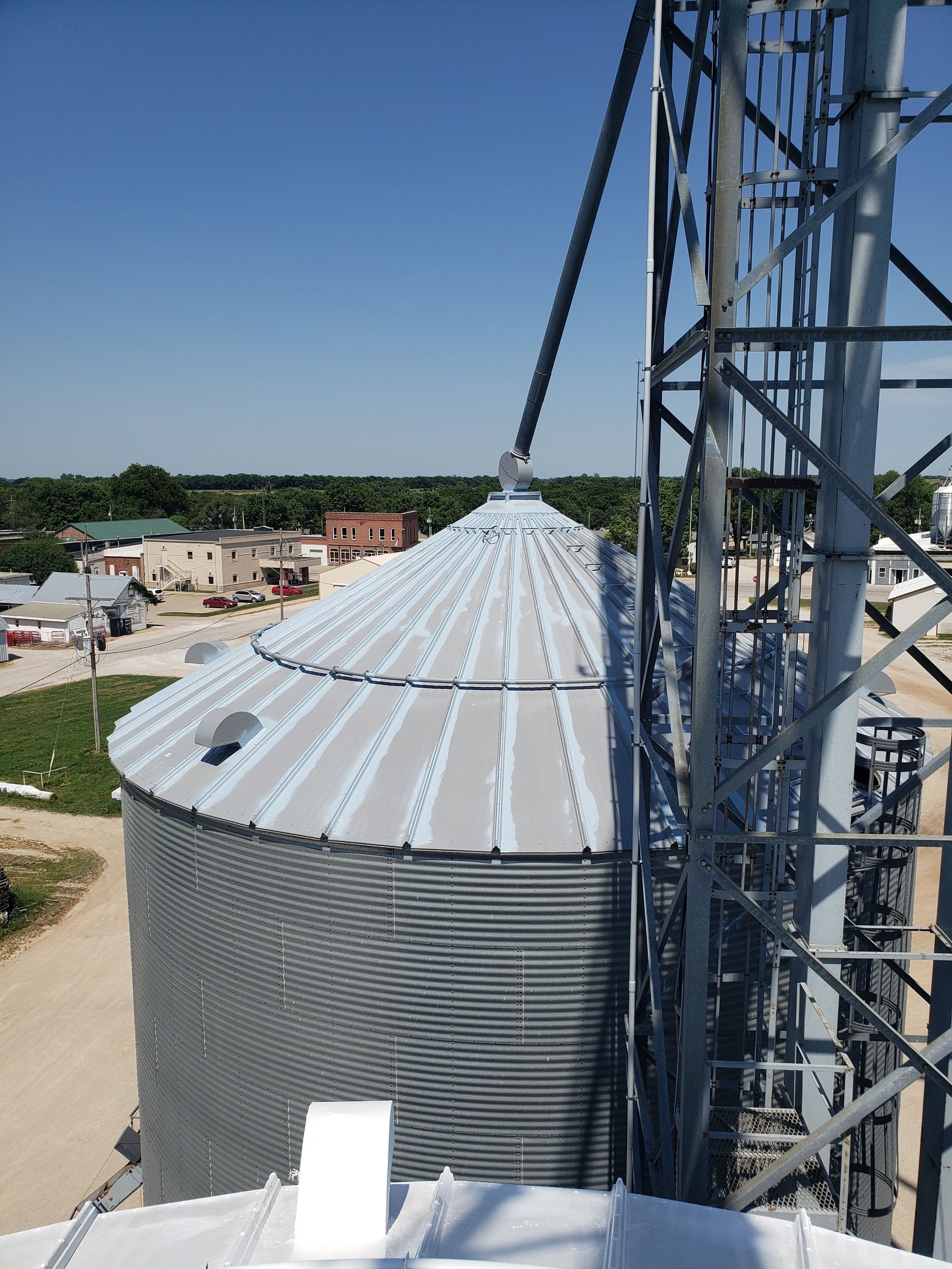 An aerial view of a silo with a blue sky in the background