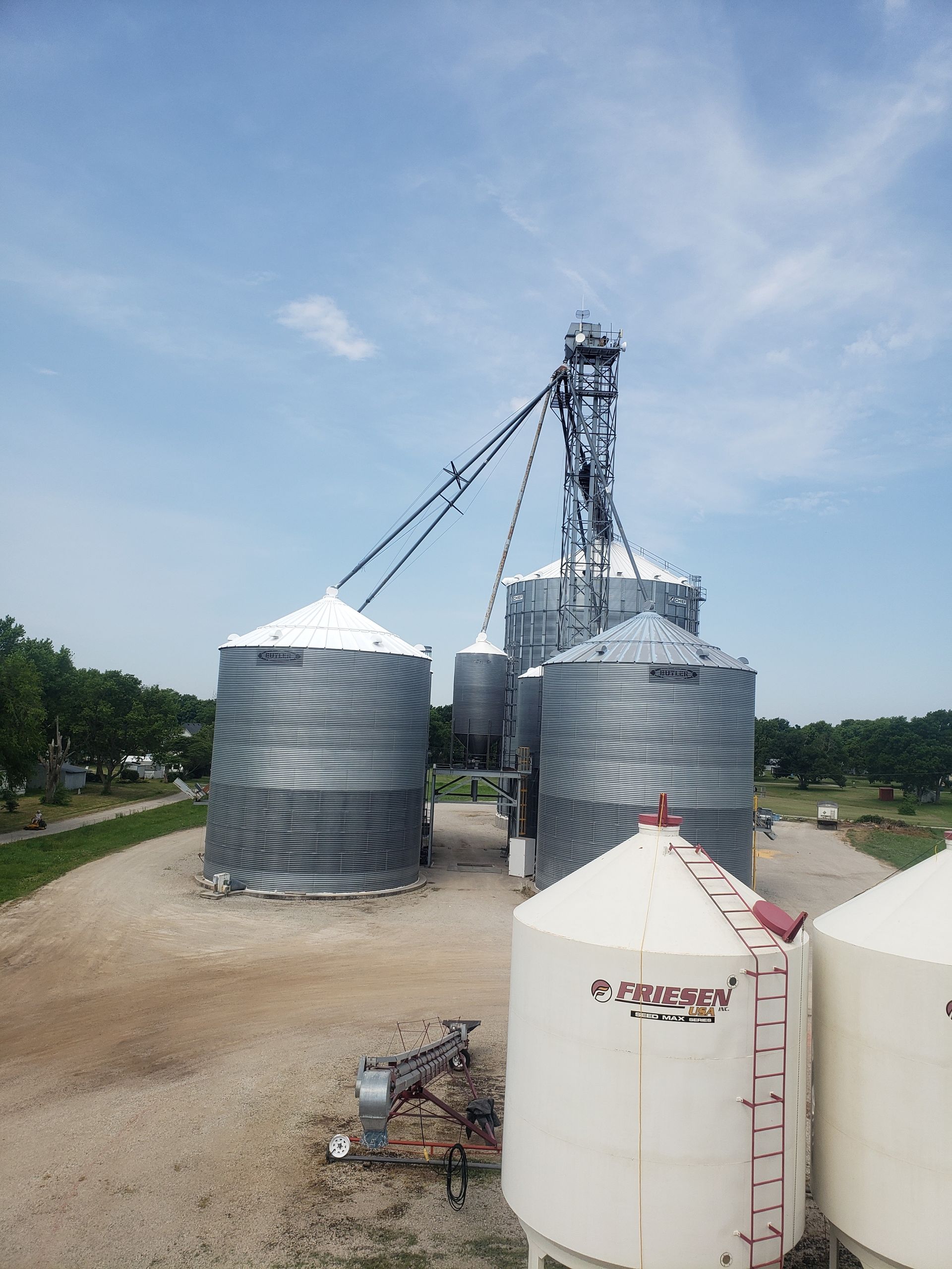 A row of silos in a field with a blue sky in the background