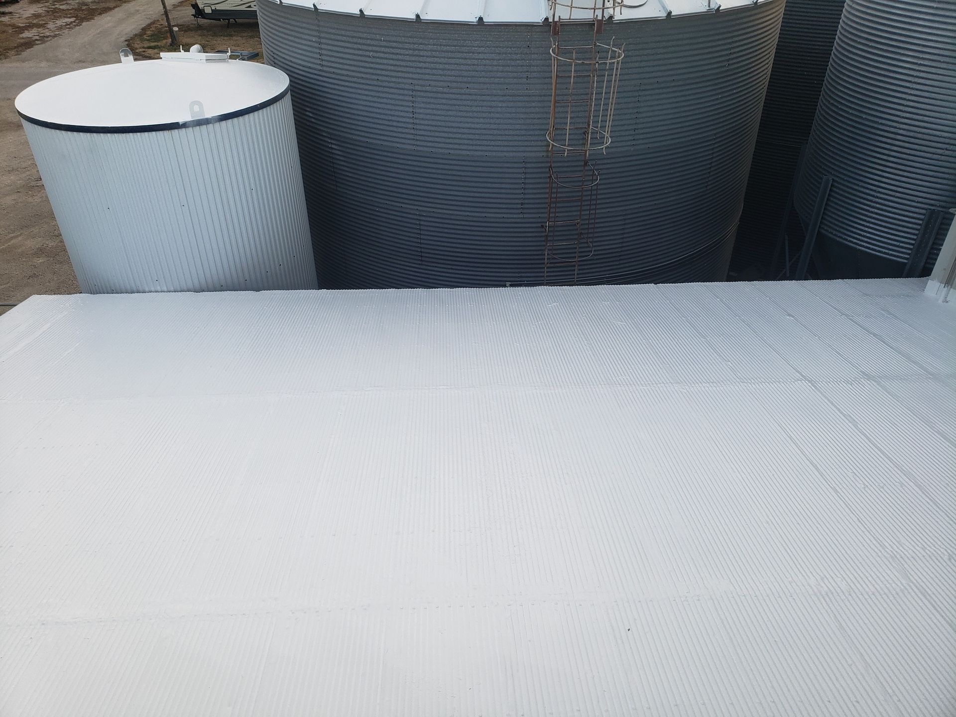A group of silos sitting next to each other on top of a white surface.