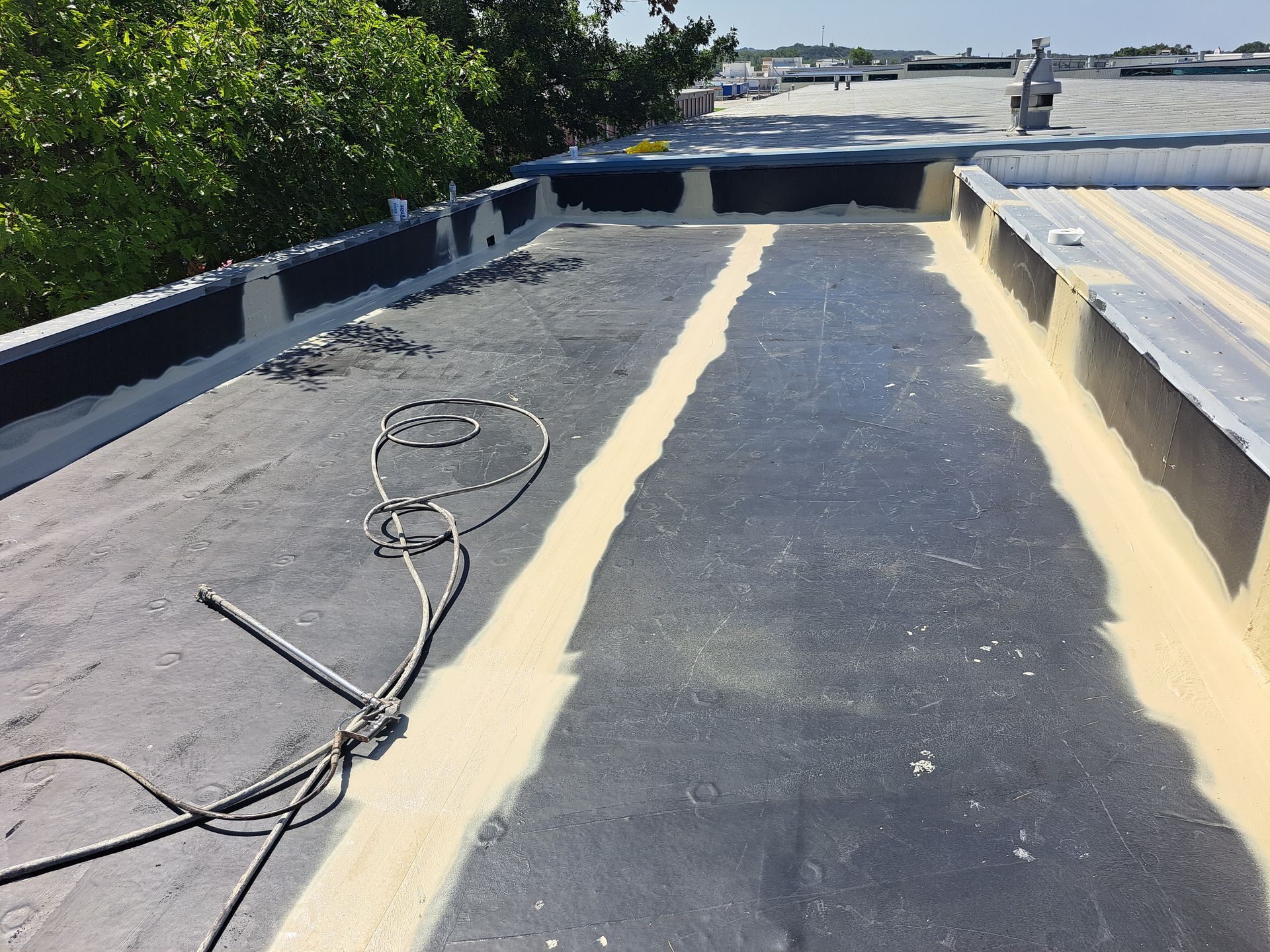 A roof with a few wires hanging off of it