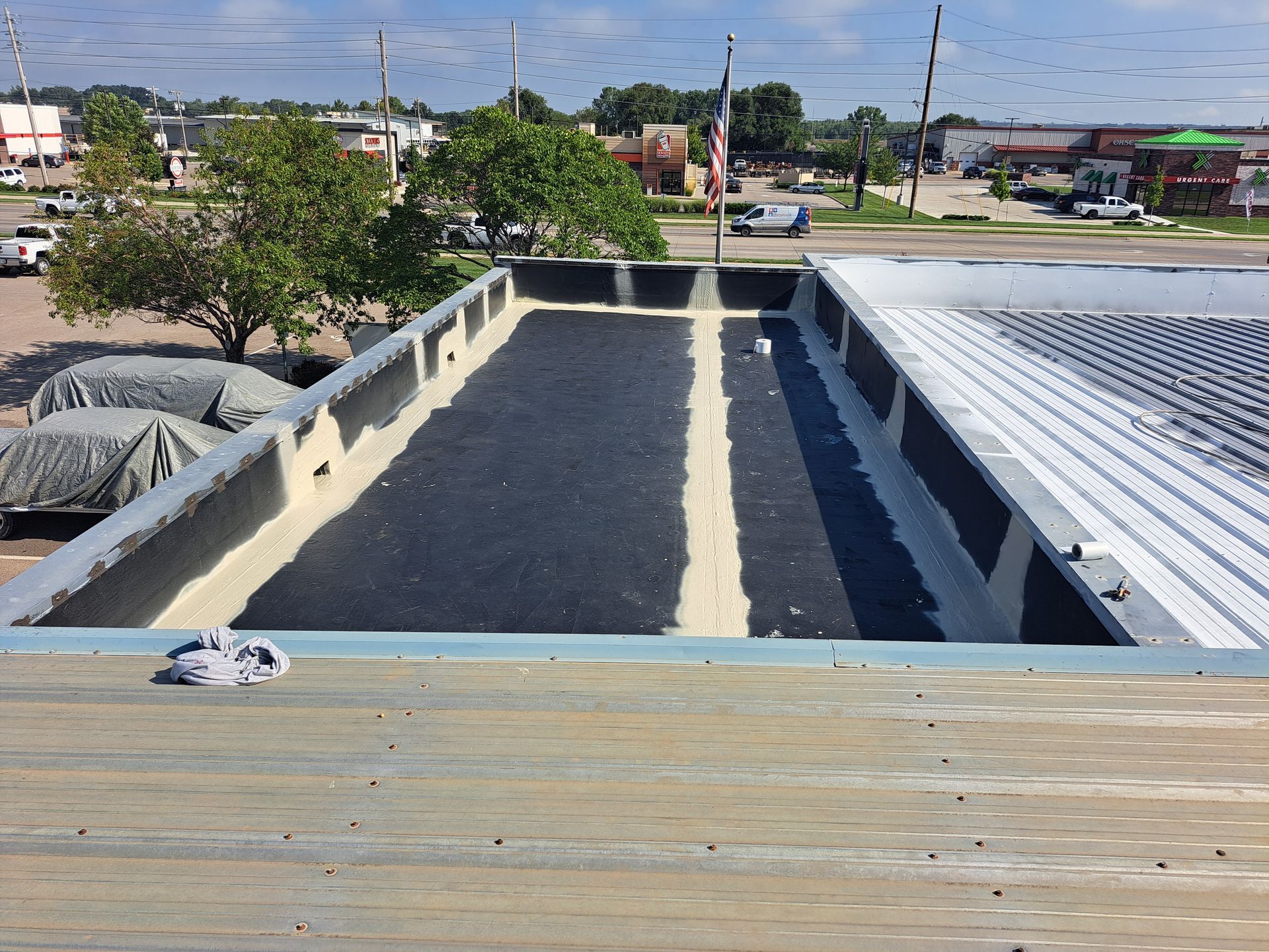 The roof of a building is being painted black and white