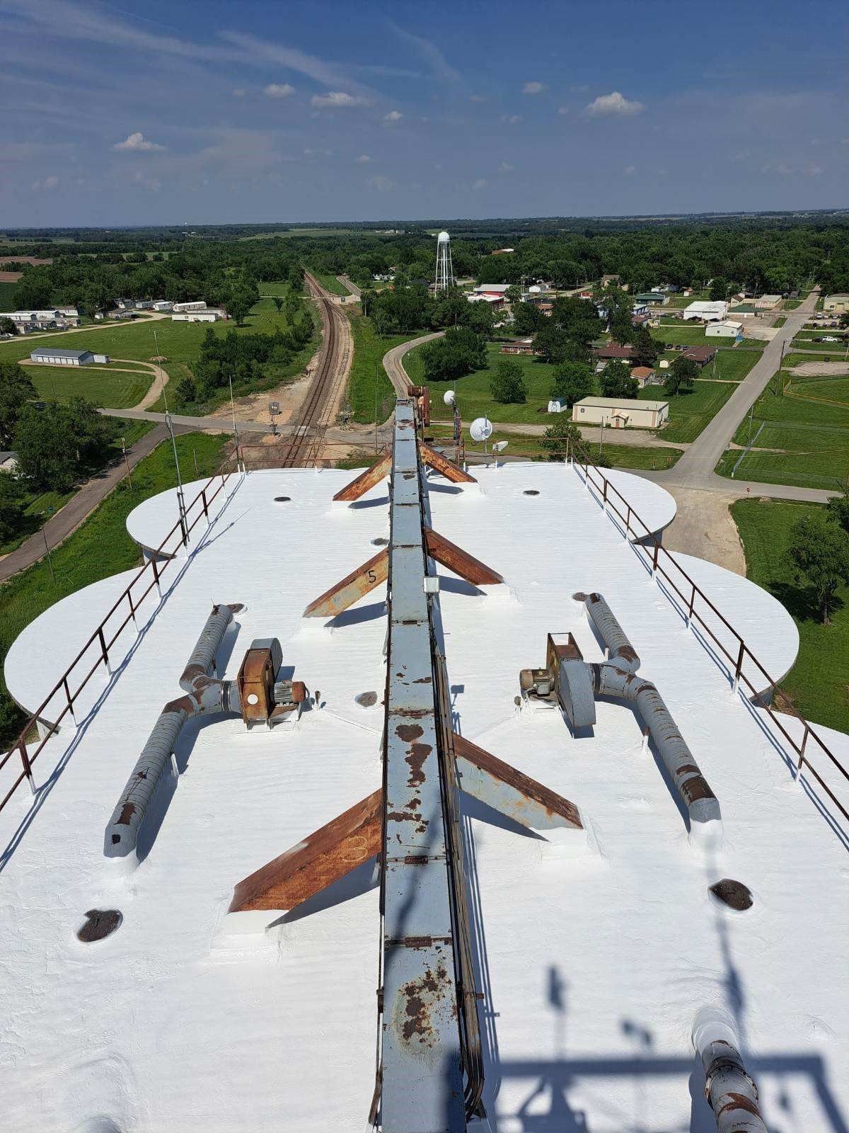 An aerial view of the roof of a building with a white roof.