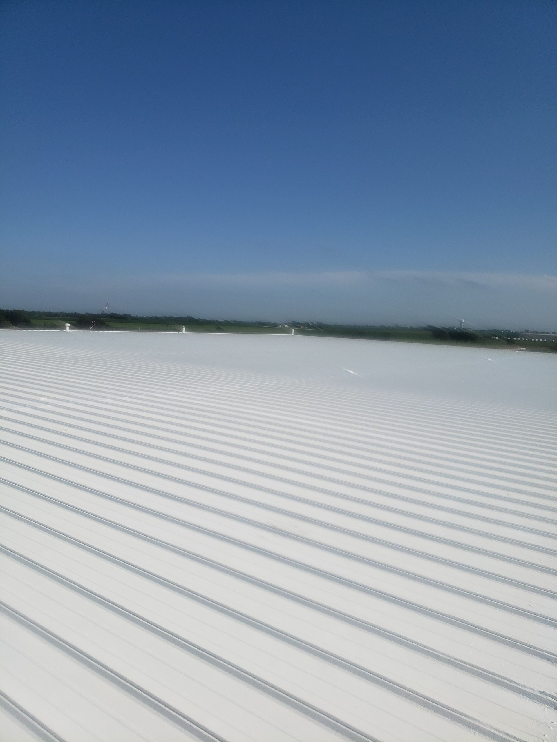 A white roof with a blue sky in the background