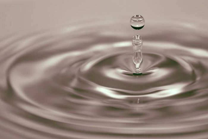 A droplet of water showing the ripple effect.