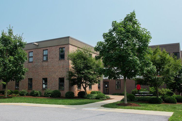 A large brick building with trees in front of it