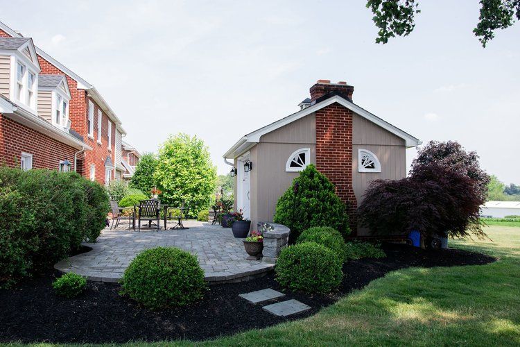 A small house with a patio in front of it.