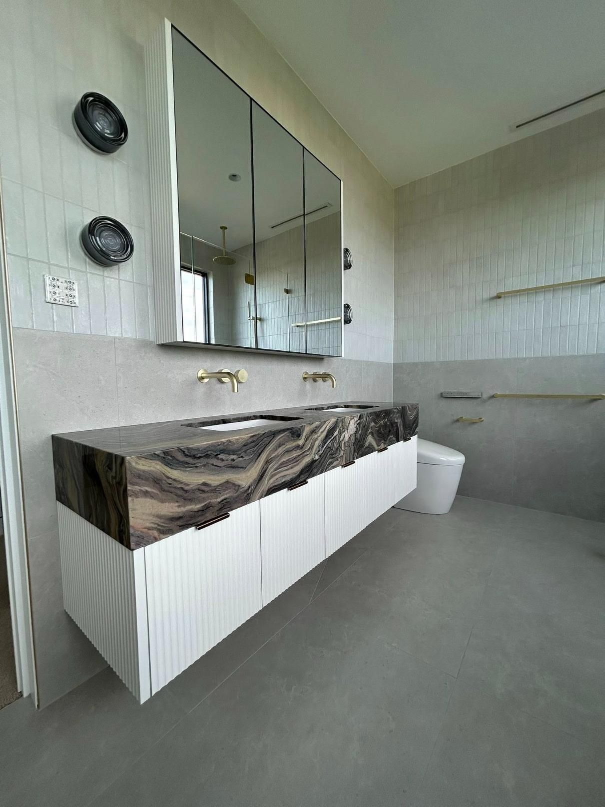 A Bathroom with A Sink, Toilet and Mirror — Inovative Interiors In Cardiff, NSW