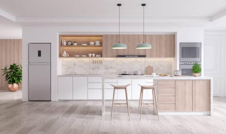 A Modern Kitchen with White Cabinets and Wooden Floors — Inovative Interiors In Cardiff, NSW