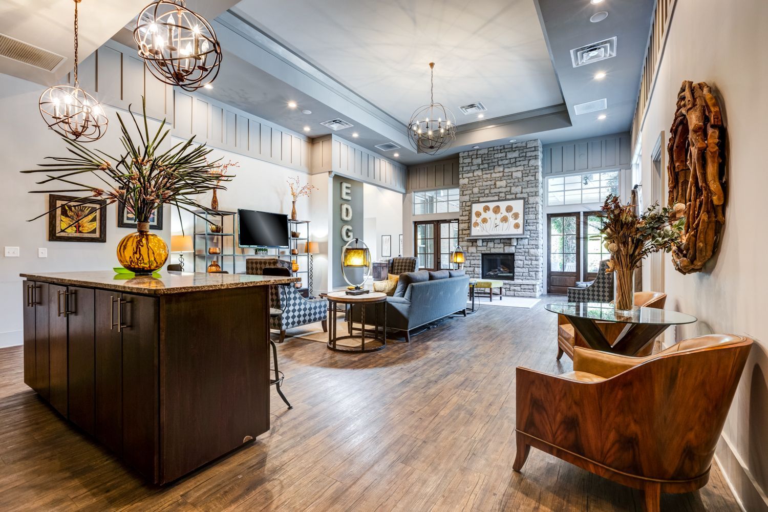 Spacious lobby with fireplace, seating area, bar, and decorative elements like art and flowers at Arcadia's Edge in Columbia, SC.