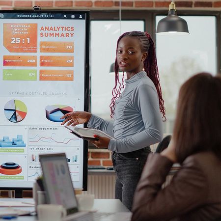 Image of a woman discussing about the business analytics summary