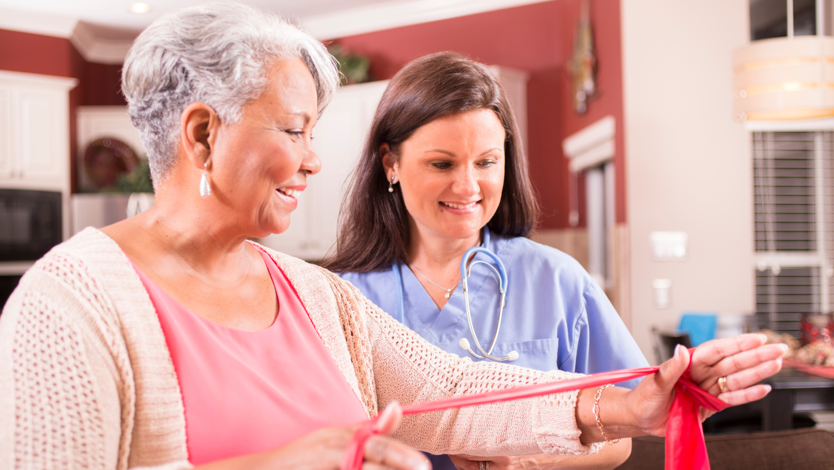 Client with her therapist doing physical therapy at home