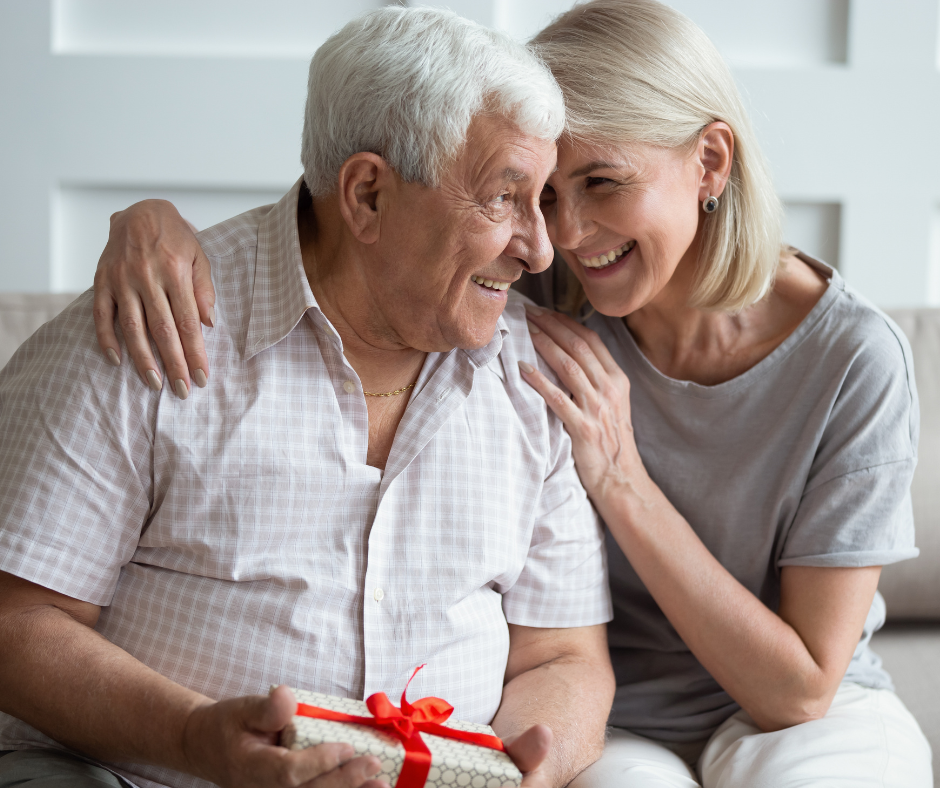 Daughter hugging aged father