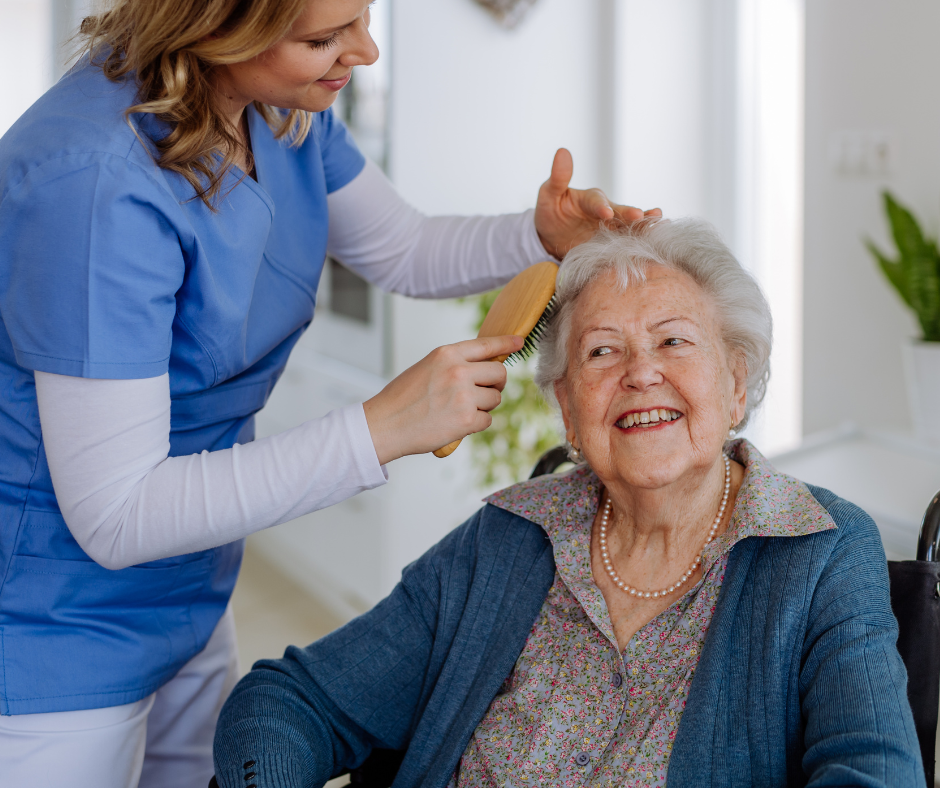 Picture of a caregiver brushing a clients hair.