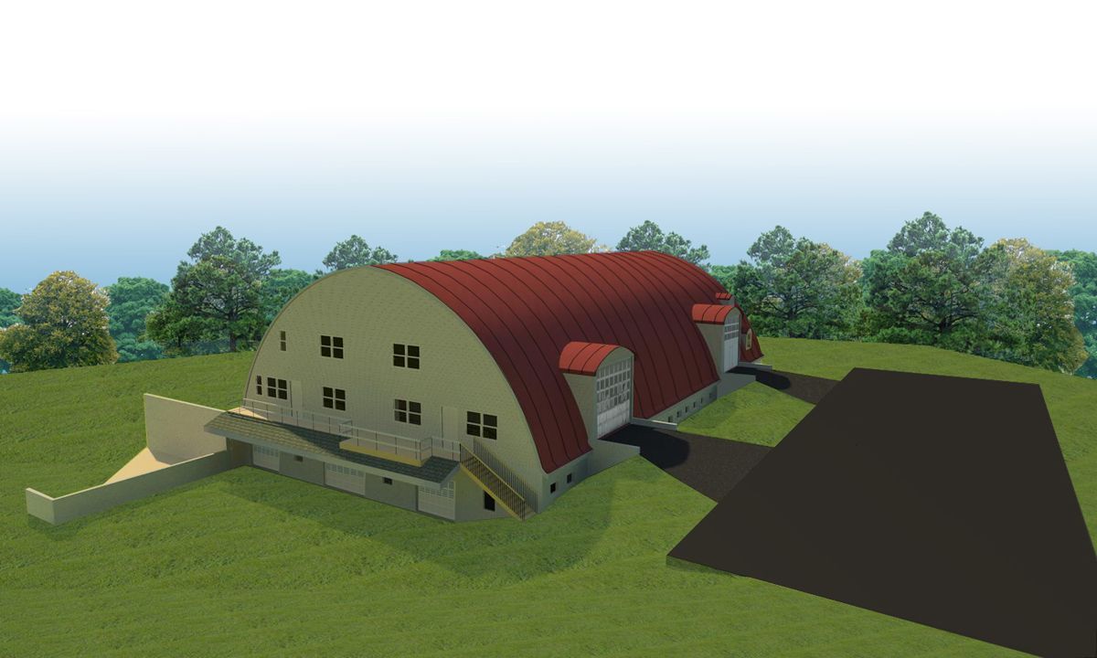 A large, curved, red-roofed building sits on a grassy hill, featuring multiple windows, side entrances, and a driveway.