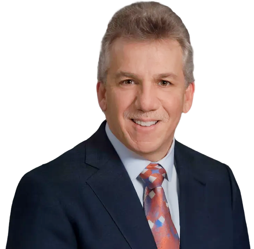 Professional headshot of a person wearing a navy blue suit, light blue collared shirt, and a patterned tie.