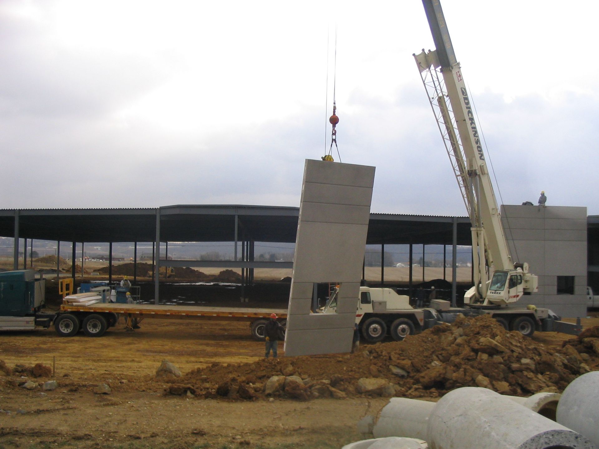 Indoor swimming pool with lanes, starting blocks, and red and black pennant flags hanging above the water.