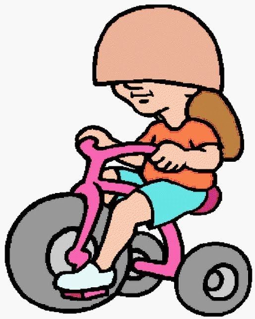A person wearing a large helmet over their eyes while riding a pink tricycle.