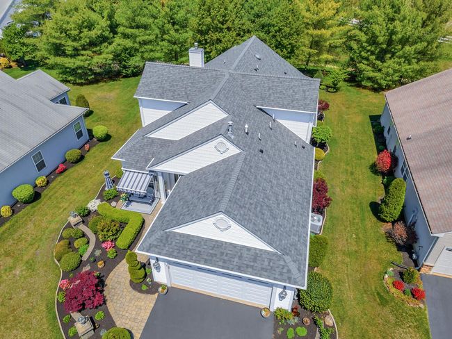 An aerial view of a house with a gray roof